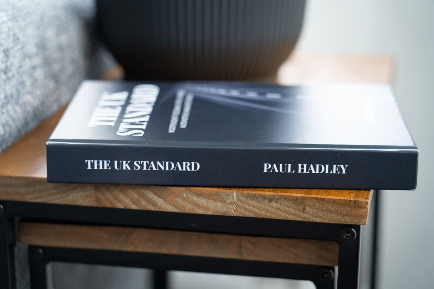 The UK Standard report, a matte black paperback with serif title typography