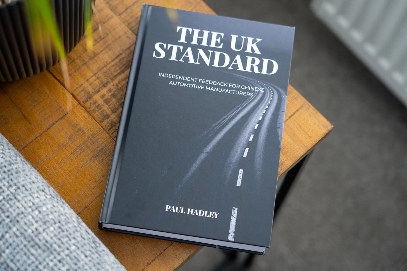 The UK Standard report, a matte black paperback with serif title typography