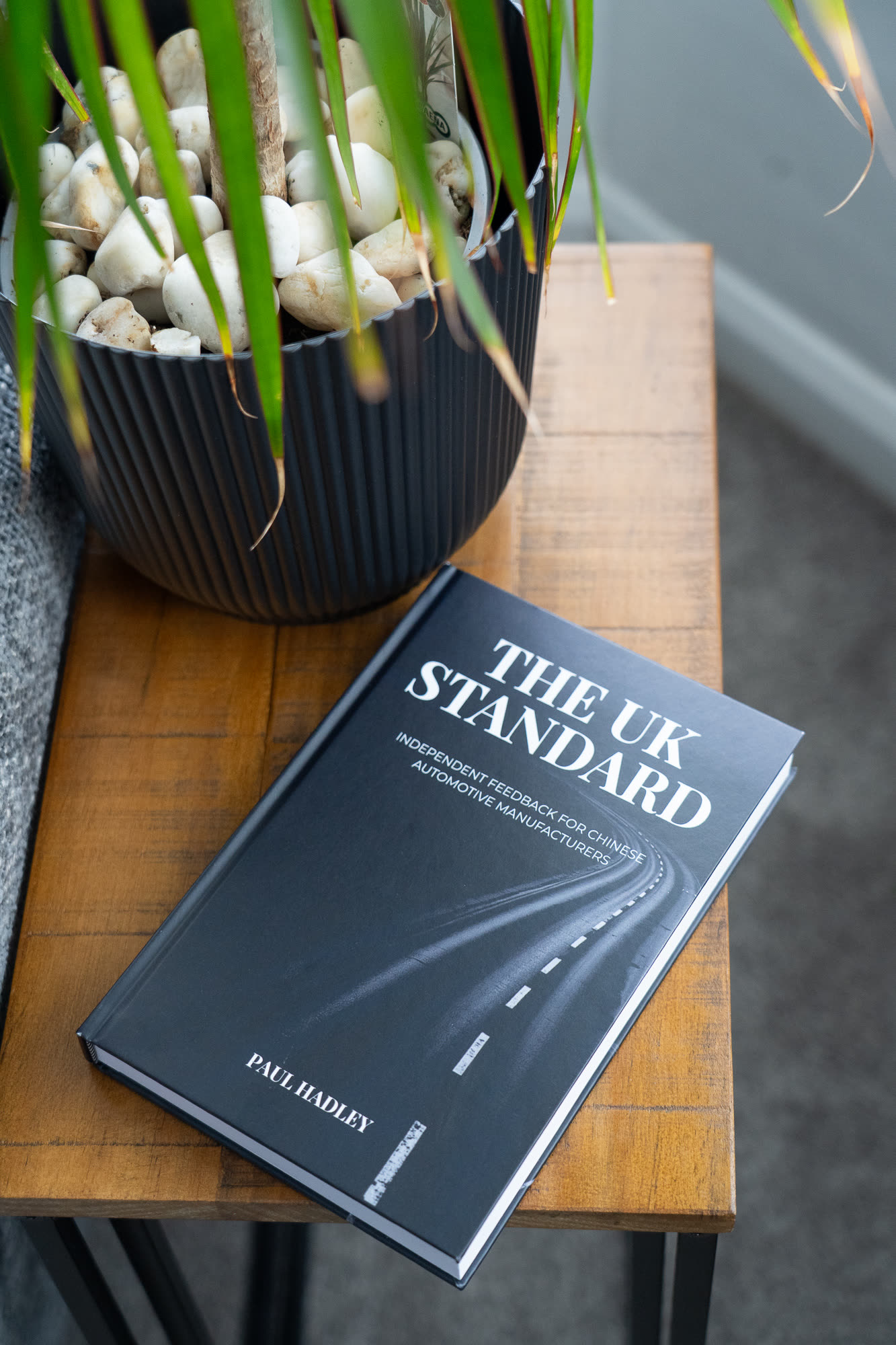 The UK Standard report, a matte black paperback with serif title typography